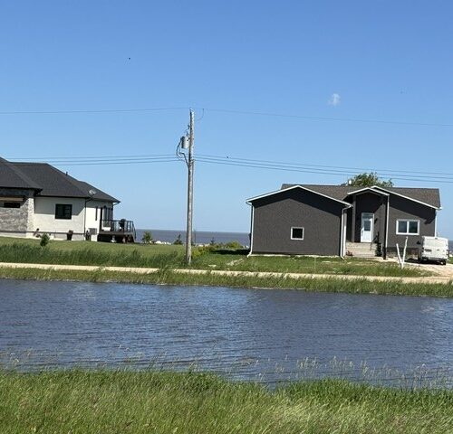 Facing north from across the160-ft wide canal lake in the background-houses-are-high-and-dry